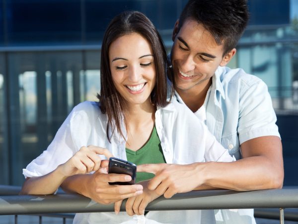 Happy young couple with smart phone